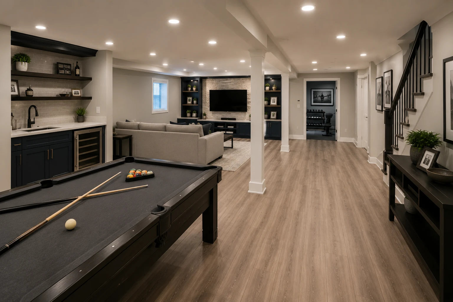 Finished basement recreation room with pool table, wet bar, media area, and durable flooring