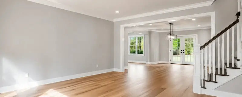 Empty room with light gray painted walls and a wood floor